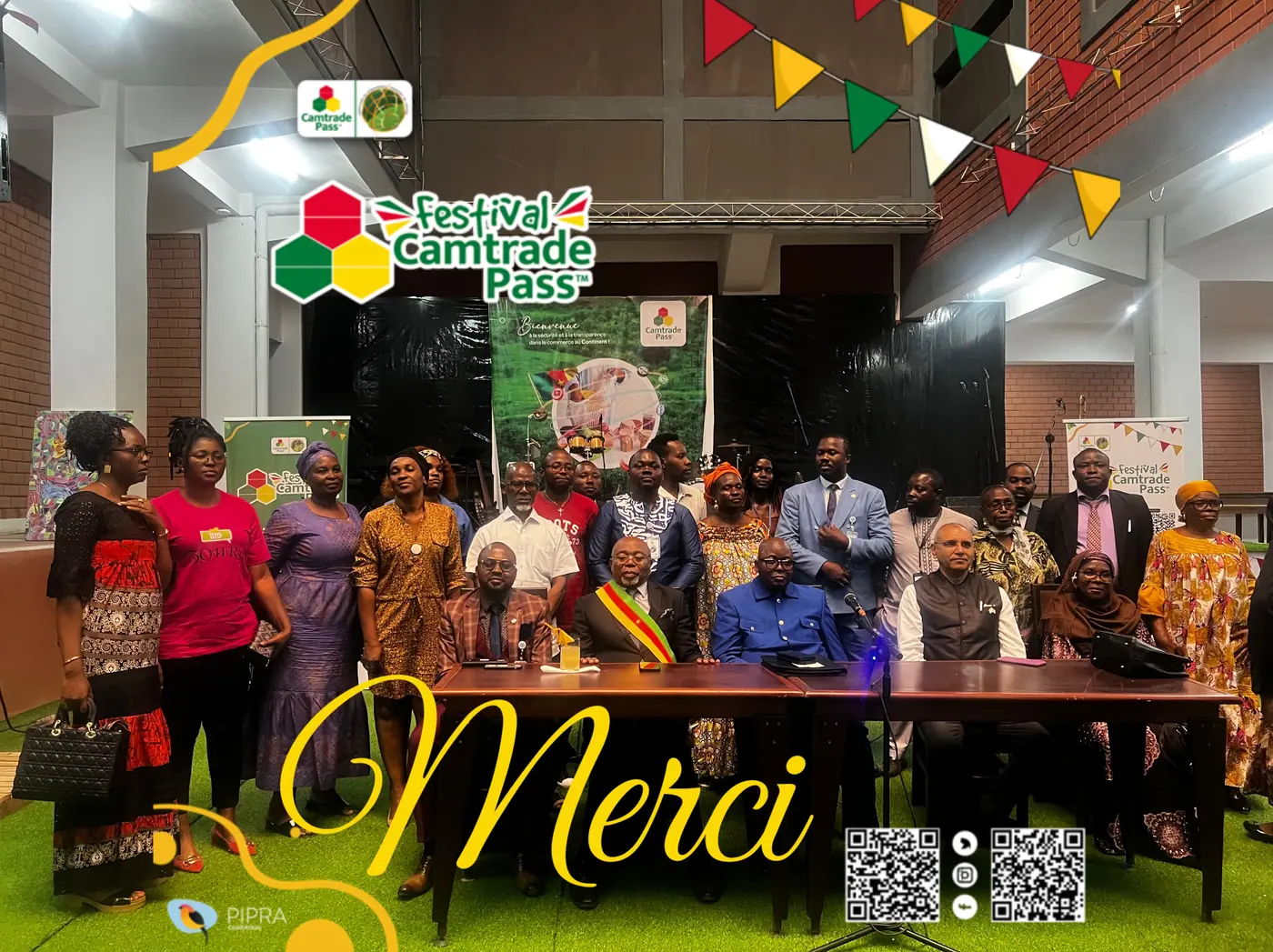 Photographie de groupe des participants réunis sur la scène du Camtrade Pass Festival, sous une guirlande aux couleurs nationales.